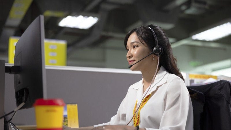 dhl express employee in the office on her computer