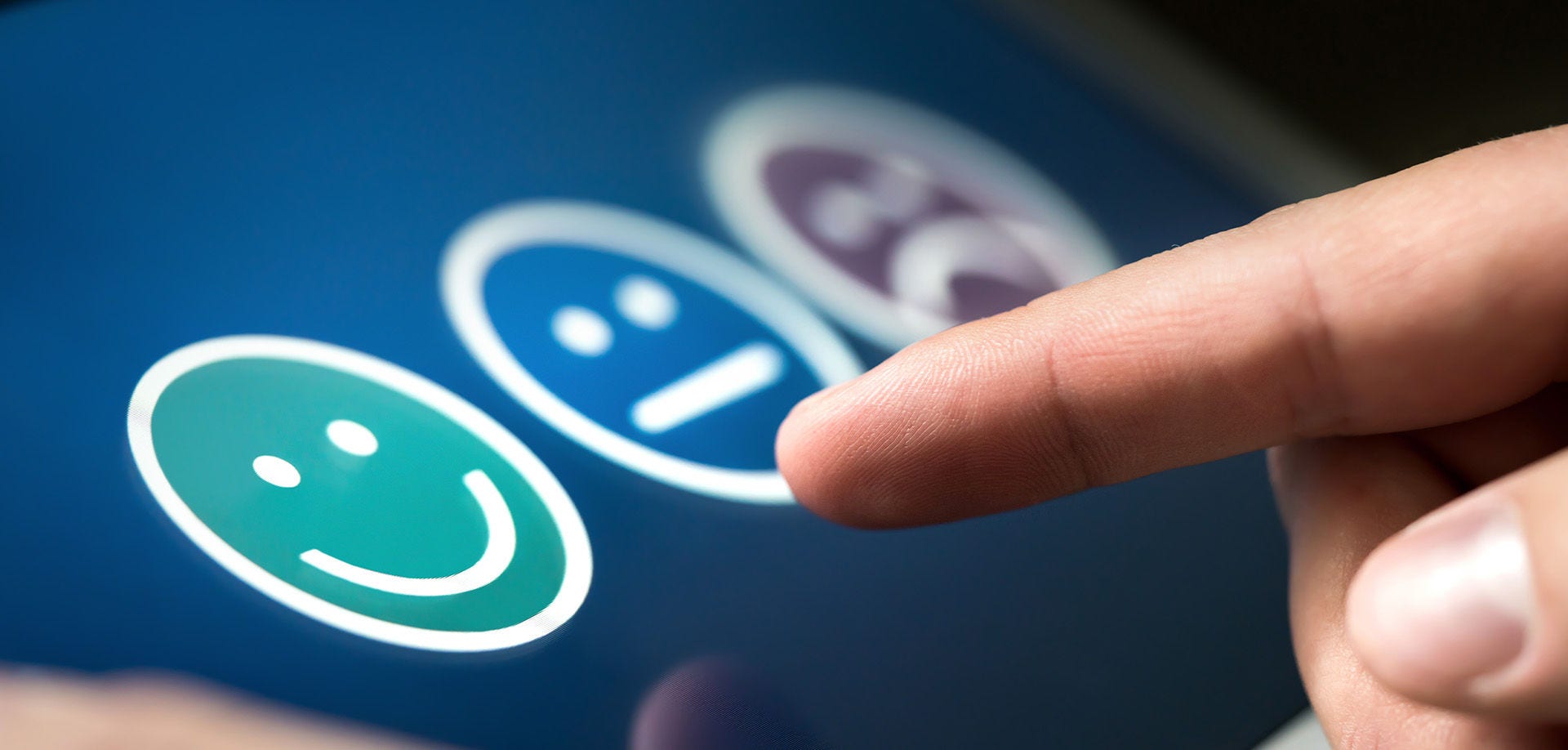 finger pointing at smiley faces