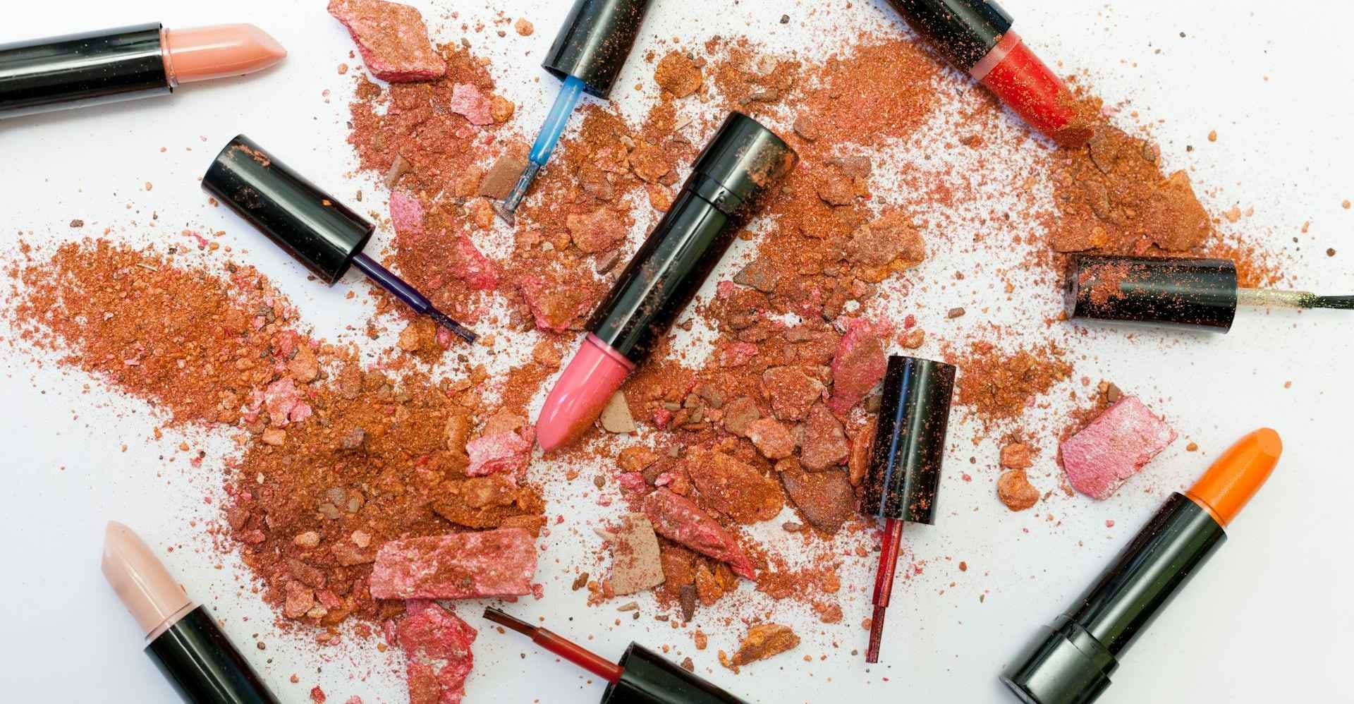 Cosmetics spread across a table full of dirt