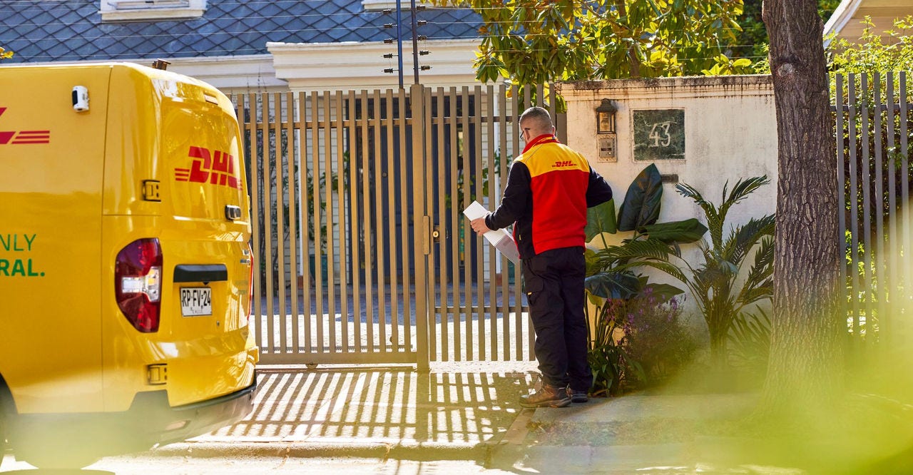 dhl express delivery agent waiting to deliver a package to a customer