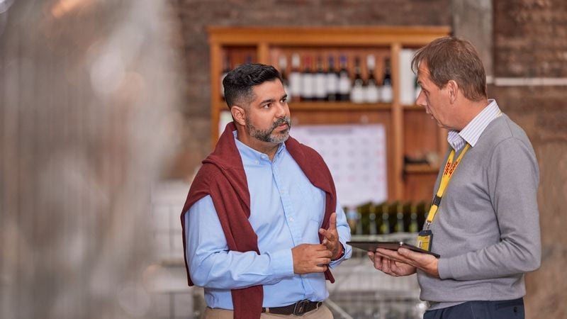 Business owner discussing international wine delivery