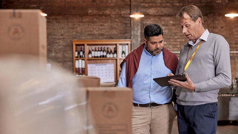 DHL Express employee discussing customs clearance to a business owner