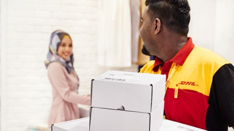 DHL Express employee picking up deliveries from a modest fashion business in Pakistan