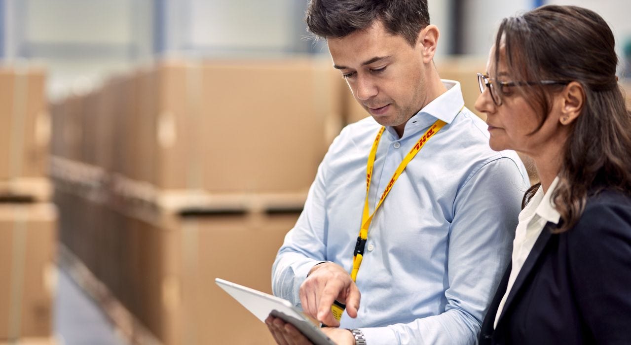 Employee and customer in a storage hall looking at a tablet