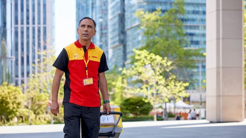 A DHL personnel engaging in its sustainable shipping services