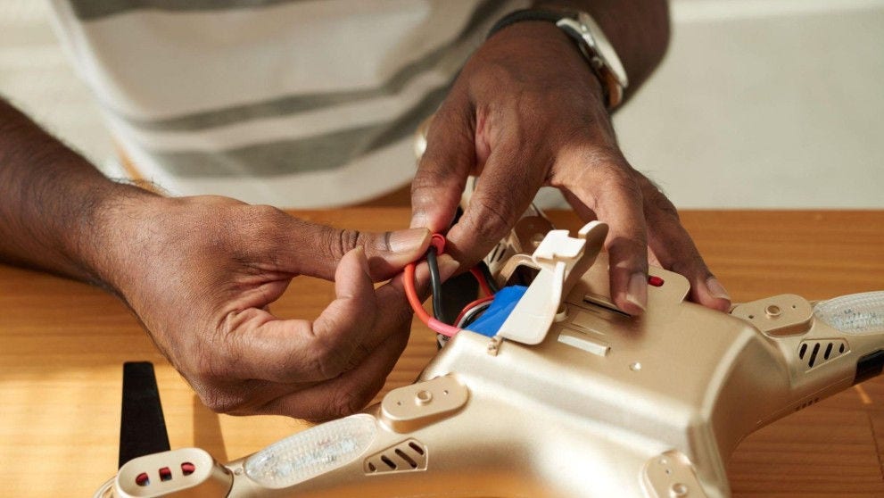 employee repairing a drone
