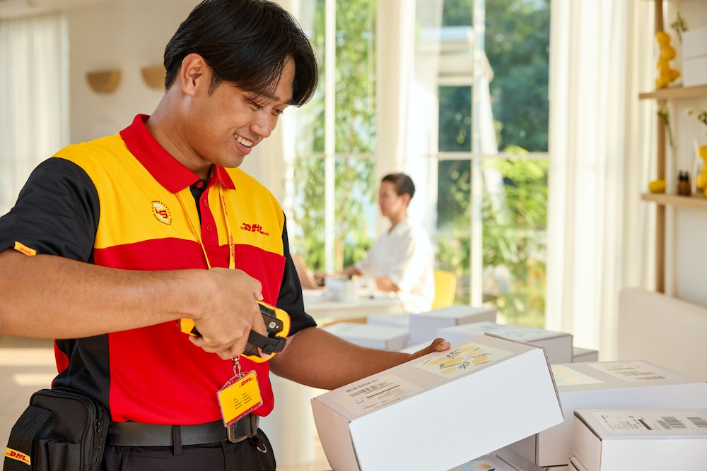 a DHL employee scans parcels for pickup