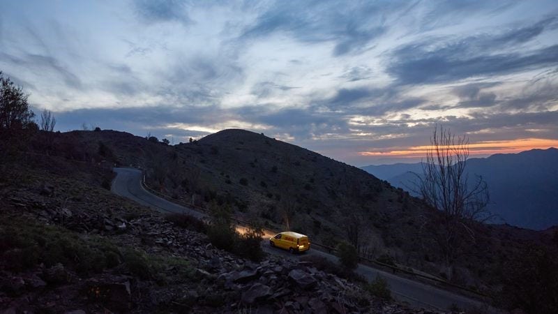 dhl express van driving on a mountain road in taiwan in the evening