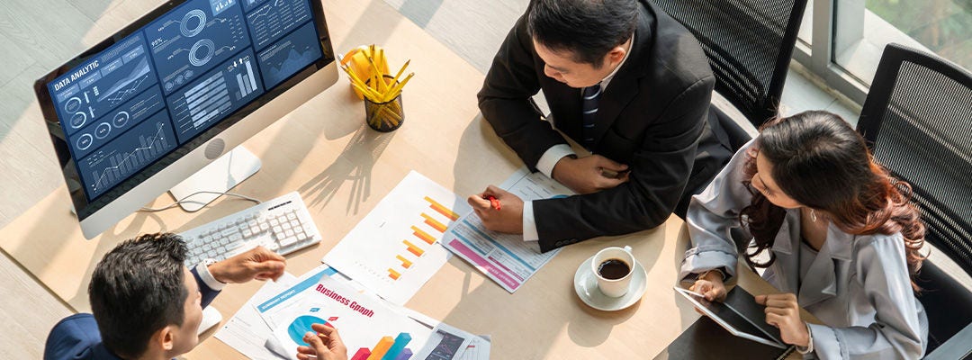 people in a meeting looking at charts