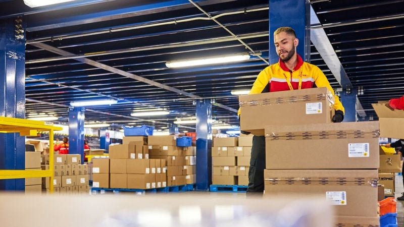 DHL Express employees sorting international exports in a warehouse