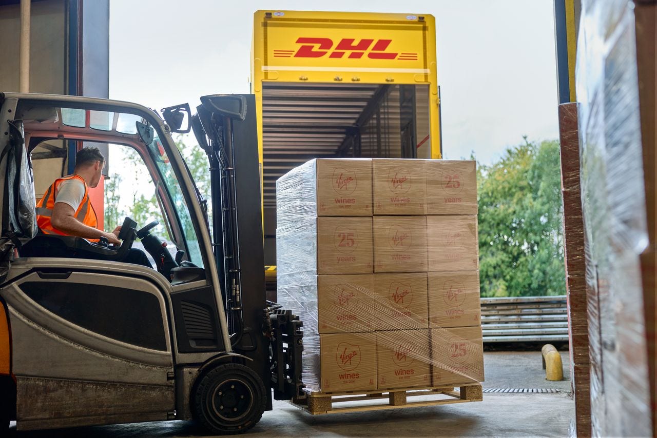 male dhl employee handling heavy shipment