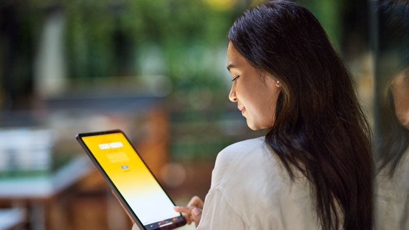 Australian creator looking at her tablet.