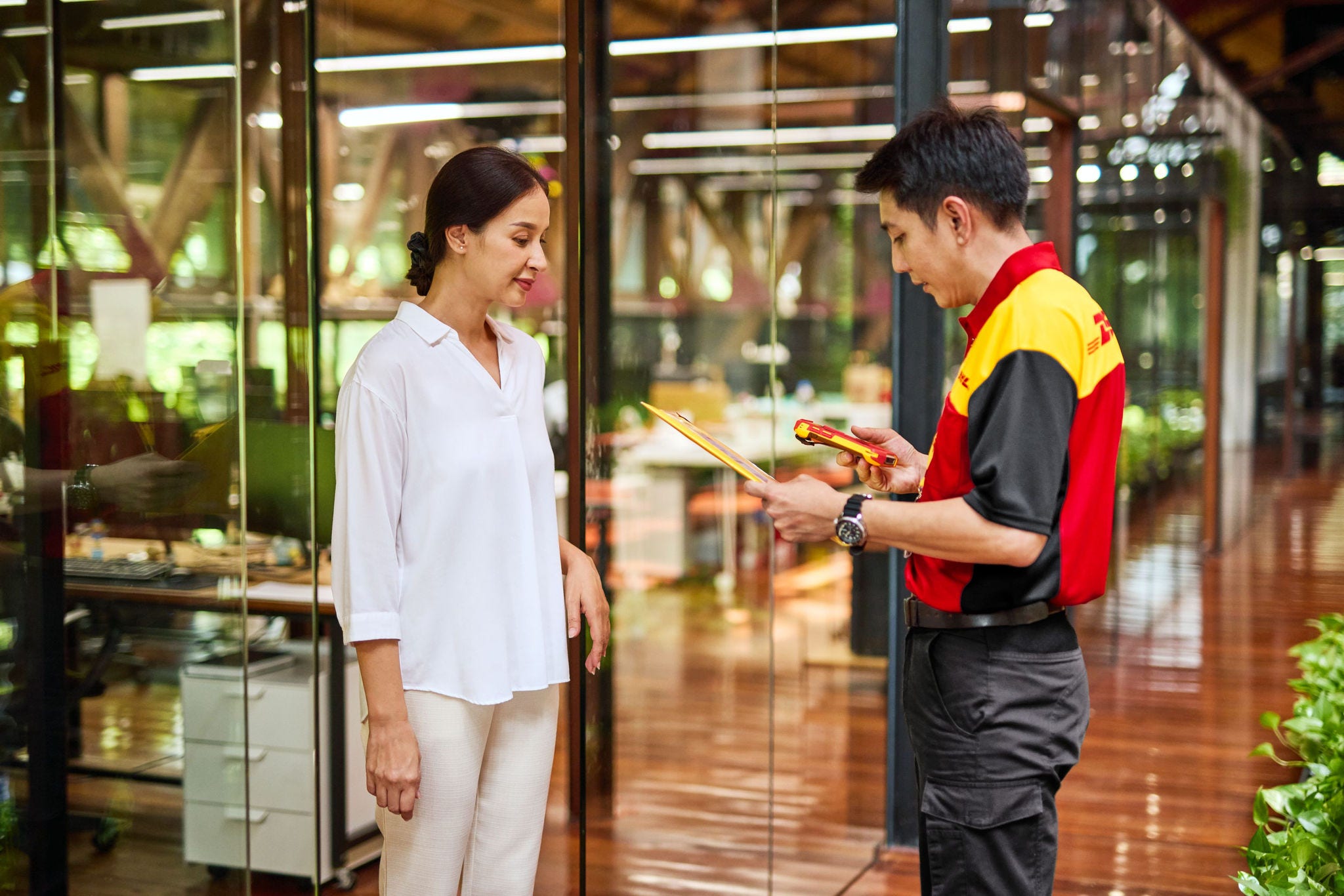 dhl express staff checking a parcel before shipping it from vietnam to the uk