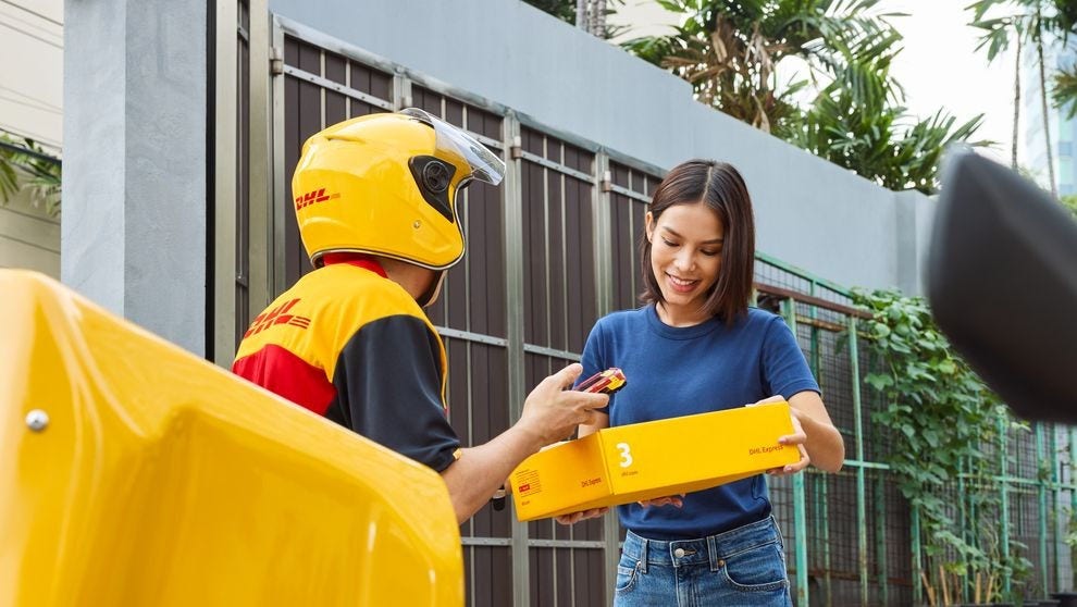 Female customer handing off a DHL Express parcel