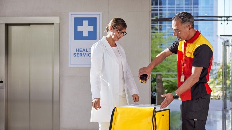 A DHL employee picking up medical supplies for cold chain delivery