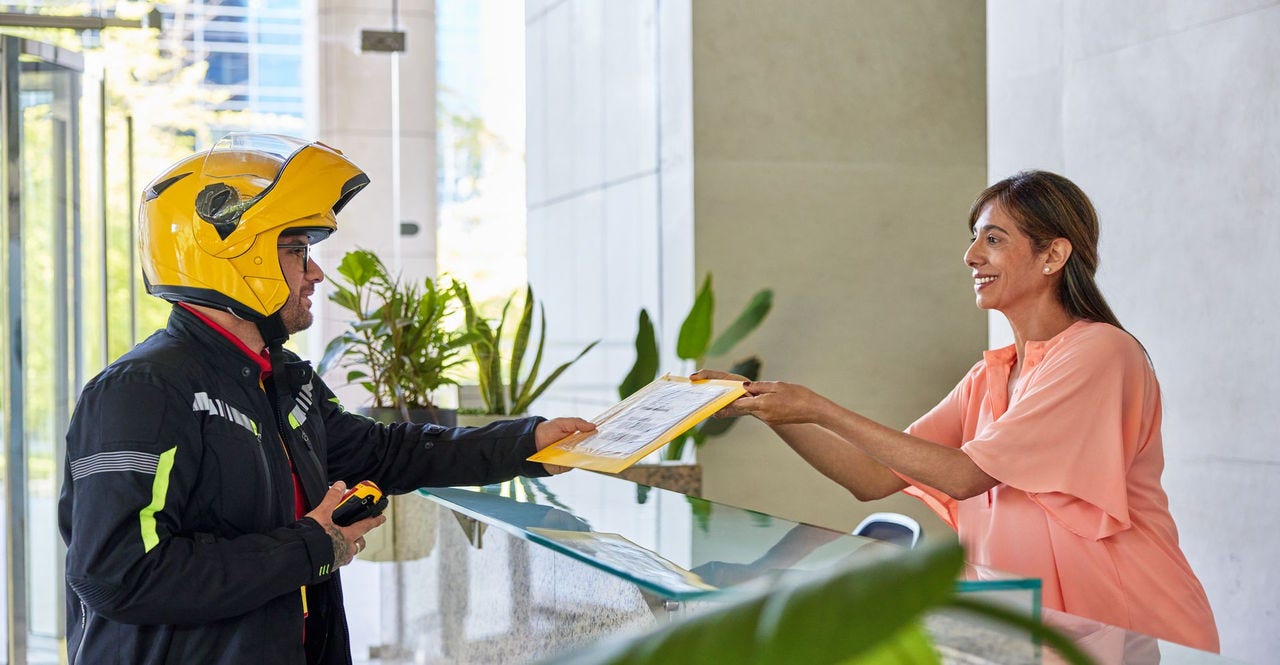 woman passing an important document for shipping to a DHL Express courier 