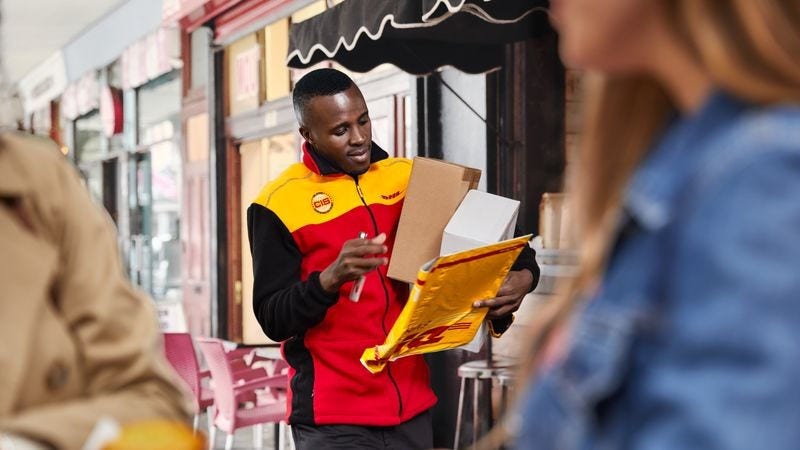 DHL Express employee with parcels shipped from hong kong to the uk