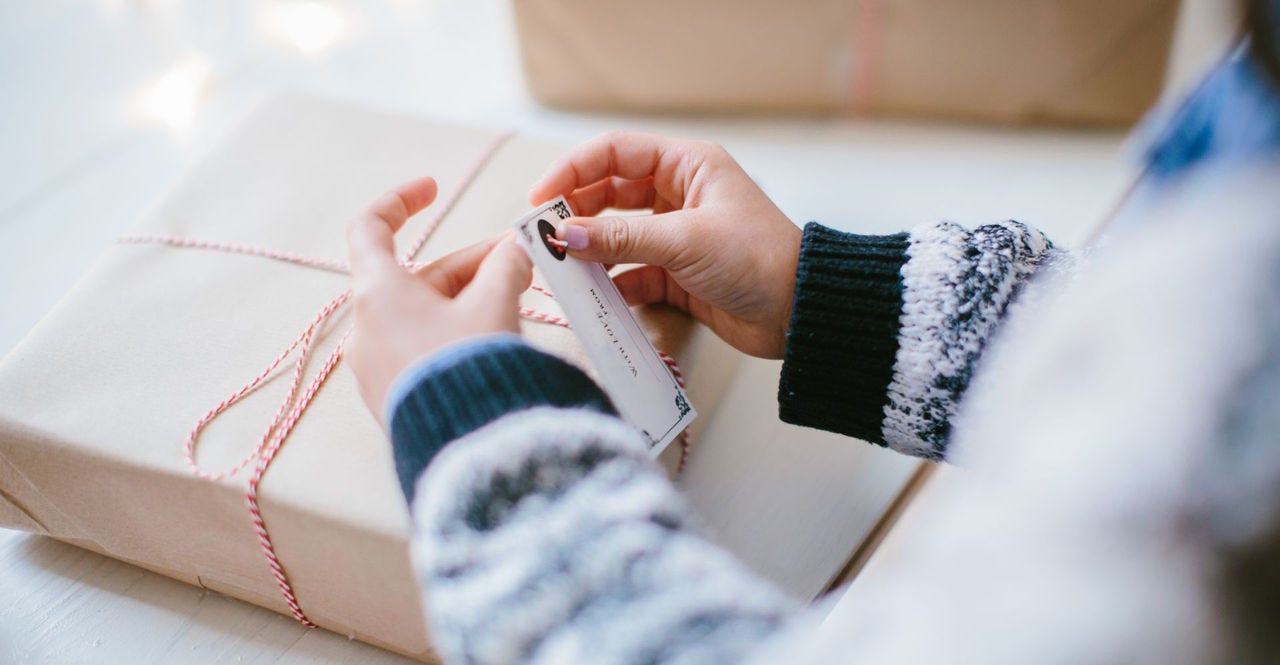 woman packing a gift box securely to minimize shipping delays during e-commerce peak season