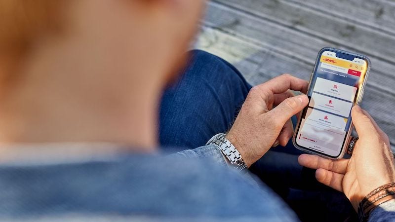A customer looks over a DHL application on their phone