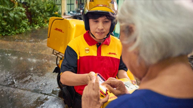 a dhl employee ensuring timely delivery avoiding cost of late delivery