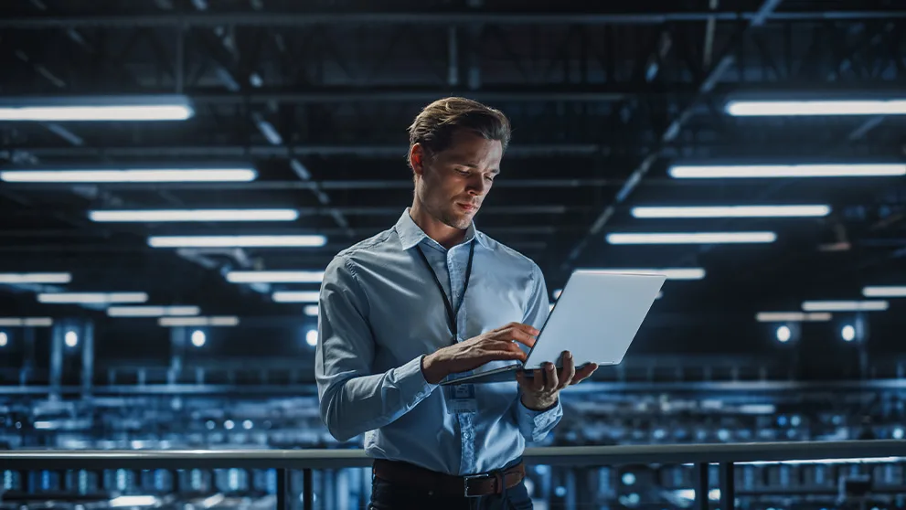 man holding a laptop