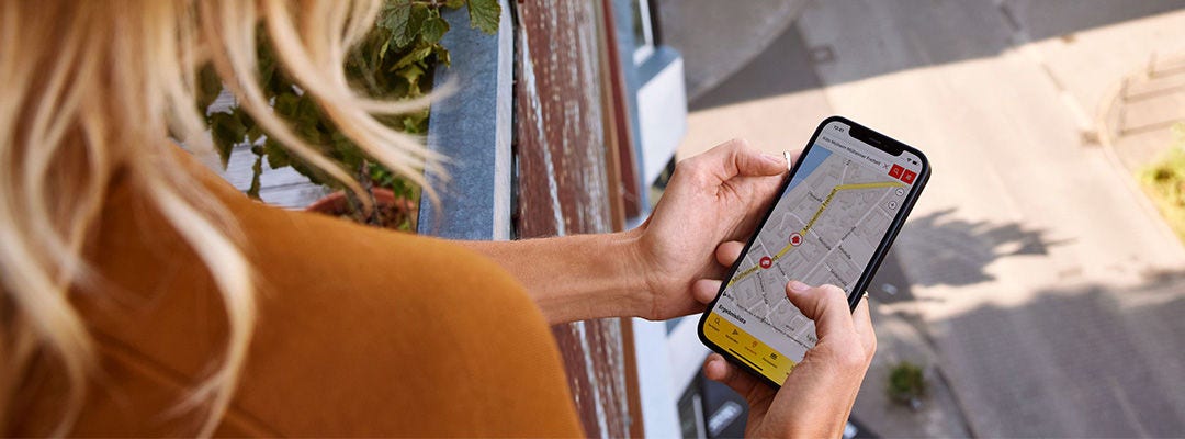 woman looking at mobile screen with a map on it tracking