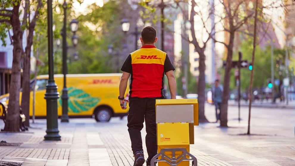 dhl express employee walking to gogreen van