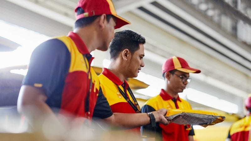 DHL Express Philippines employees sorting deliveries from a pasabuy business