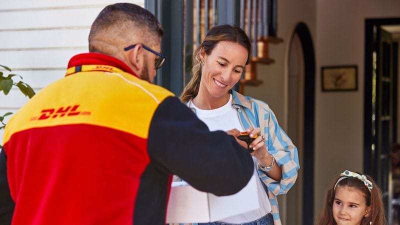 A DHL courier greets customers
