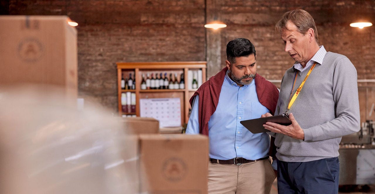 winery business owner discussing alcohol shipment with dhl staff
