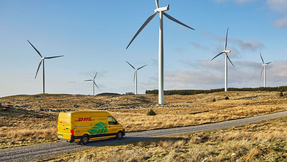 DHL van on a road with windmills
