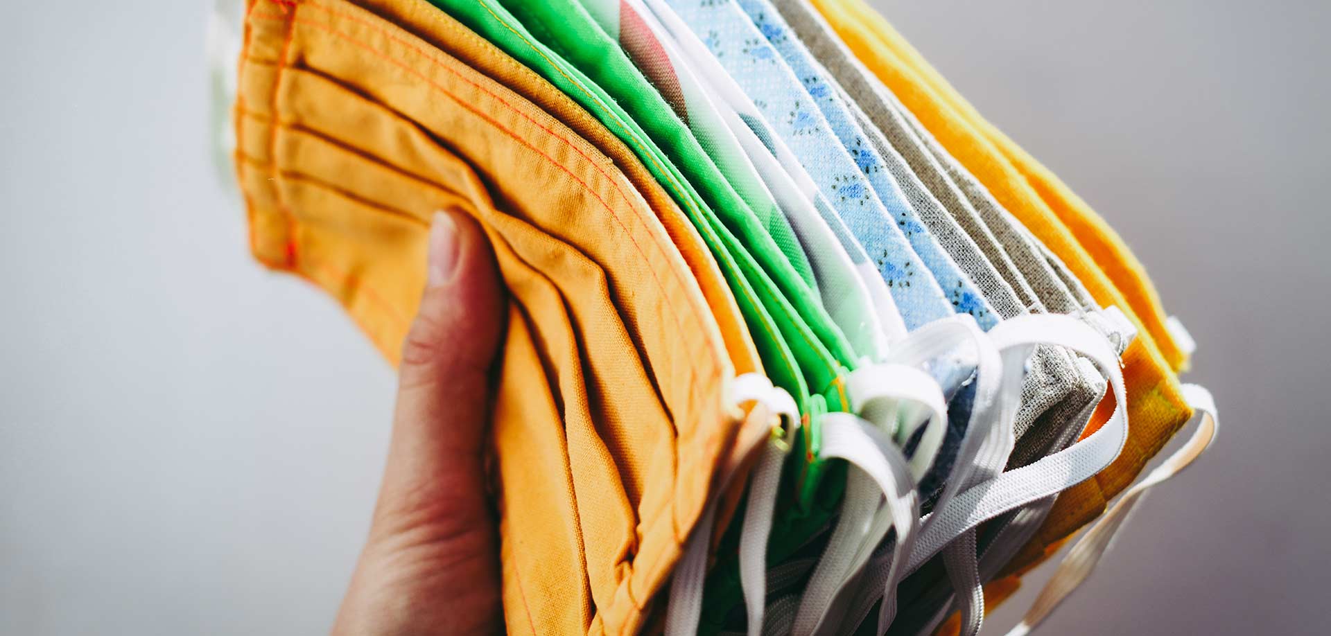hand holding cloth facemasks