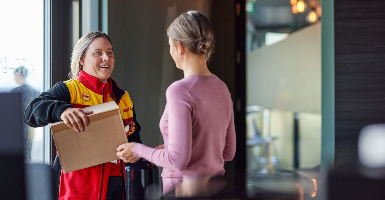 a dhl employee delivers a parcel to a customer