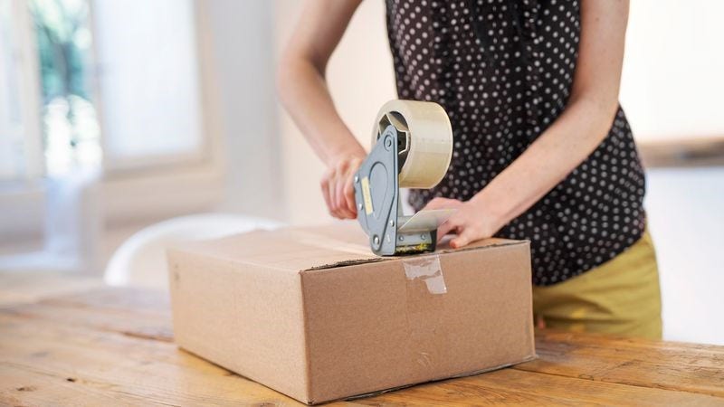 lady packing fragile item shipment before shipping