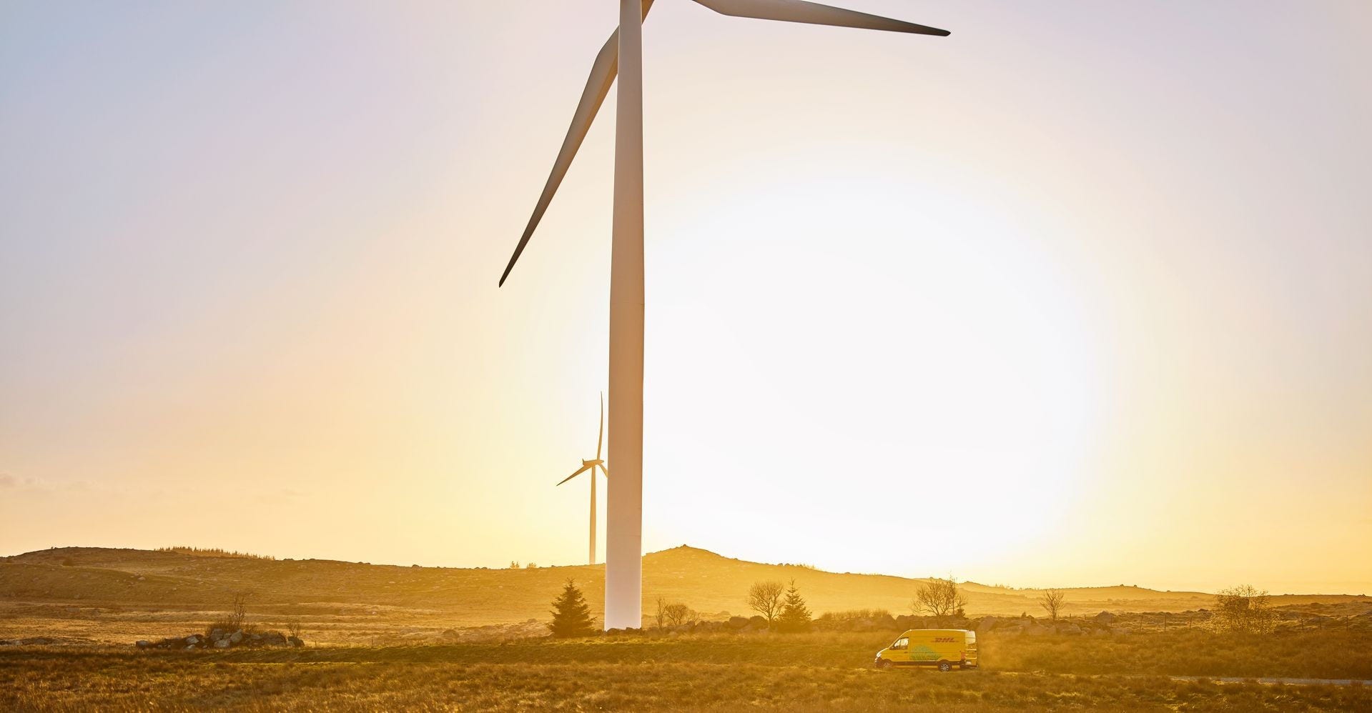 DHL Express van driving next to windmills