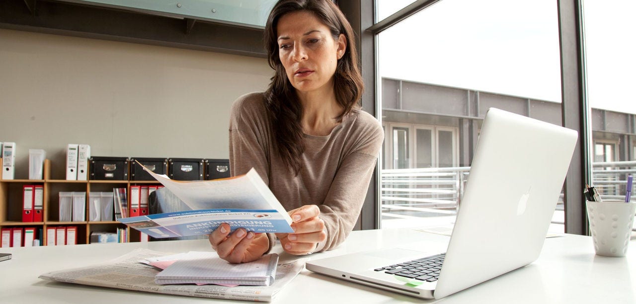 Businesswoman reviewing export documents at the office before shipment