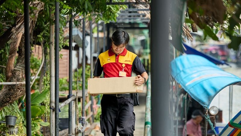 a dhl employee providing logistics services alongside the rivers of Bangladesh