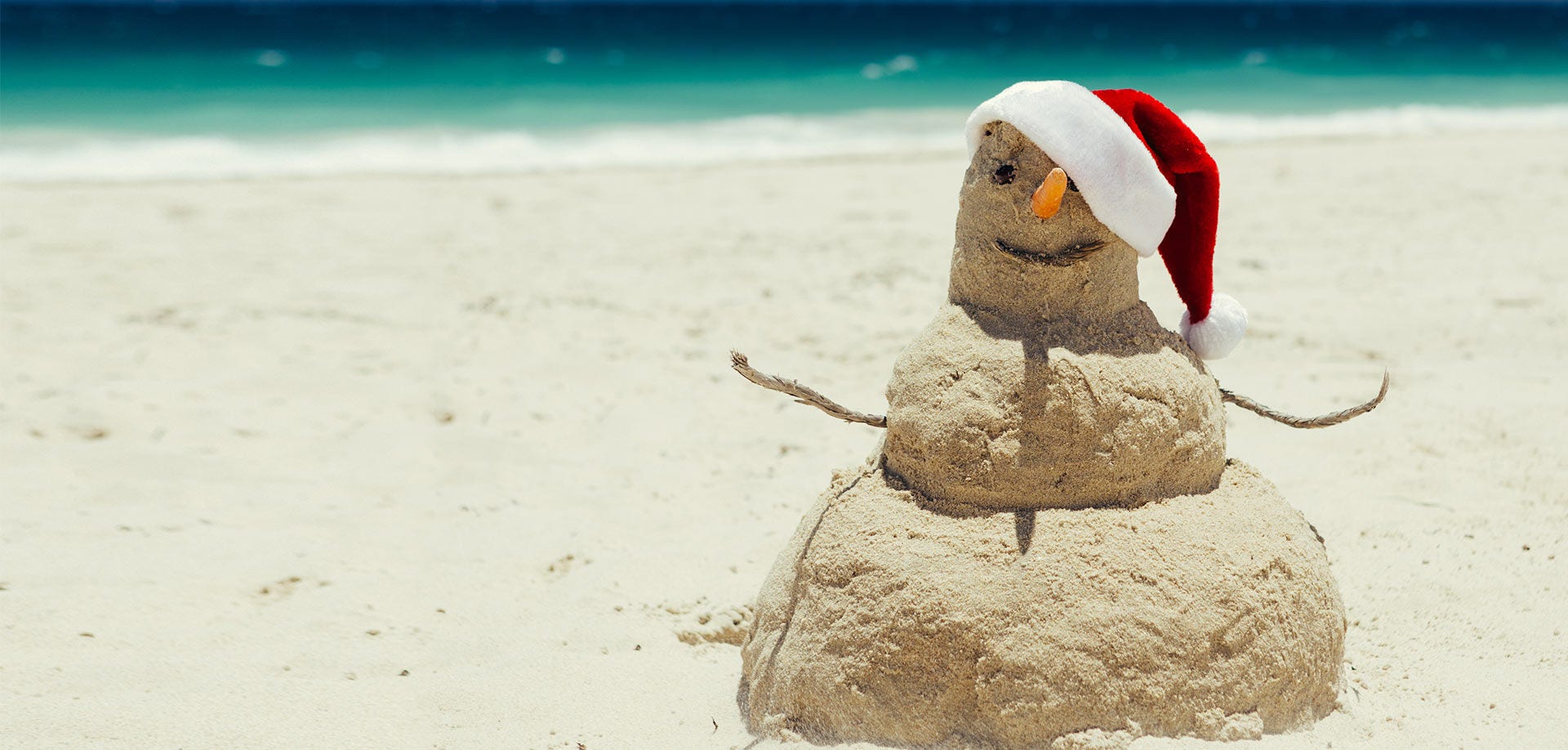 Snowman in a hat on a beach