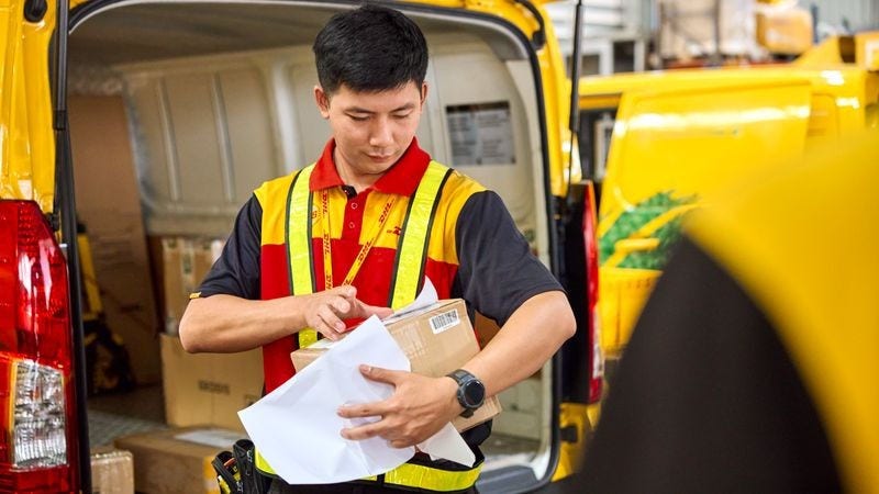 dhl express employee holding a package for delivery