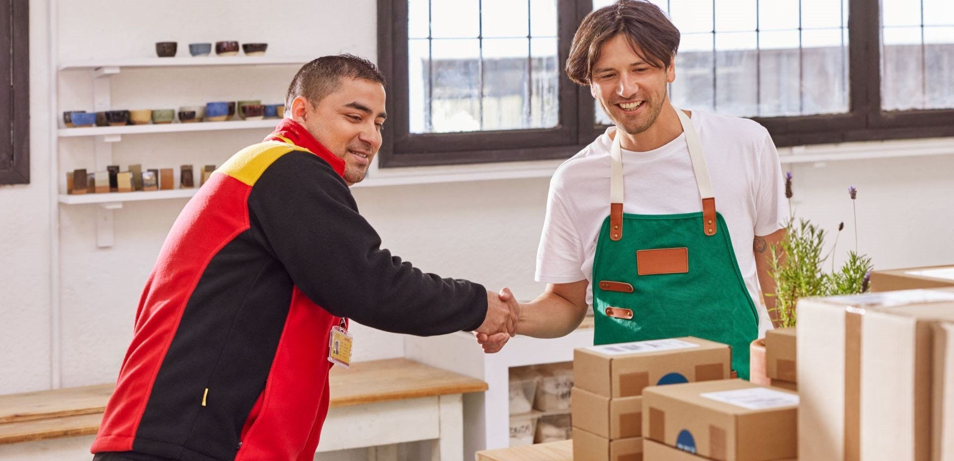 DHL courier shaking hands with small business owner 