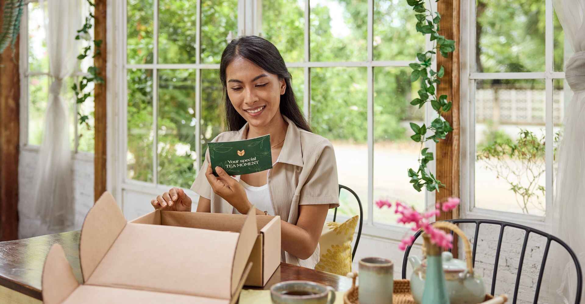 a customer unboxing a product enclosed in sustainable shipping packaging