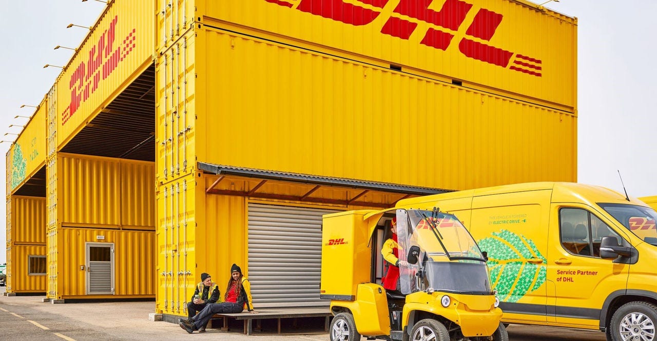 dhl employees going about their work routine outside the freight hub