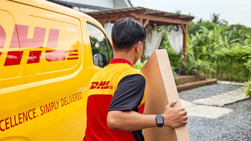 DHL Express employee delivering large parcel
