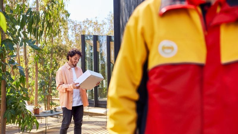 an individual receiving a package from a dhl employee