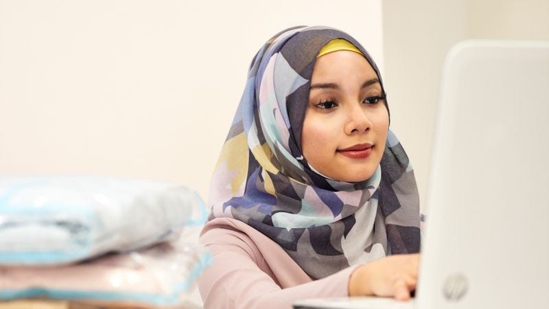 a female business owner checking vat exemptions on imported goods on a laptop