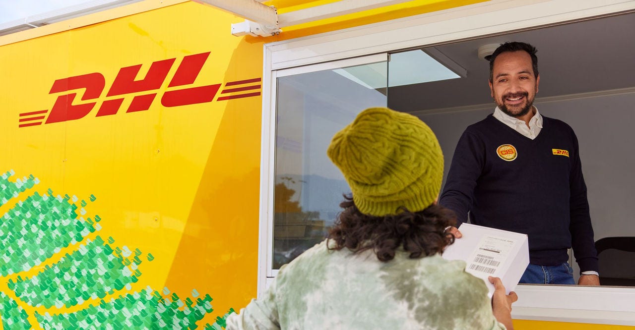 customer drops off parcel at dhl express service point following reverse logistics process