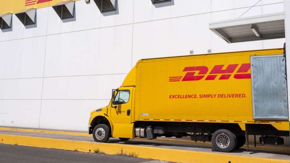 dhl express truck that offers sustainable delivery service loading oversized parcels