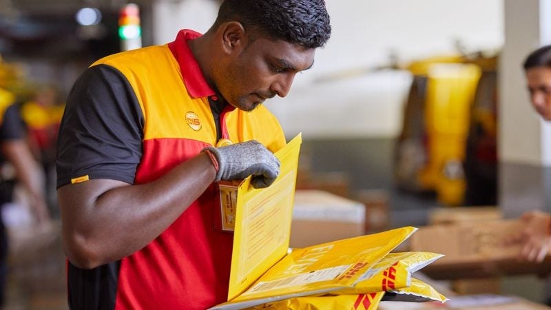 dhl express employee checking the packaging of a parcel for international shipping