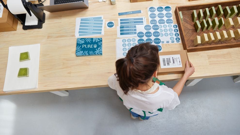 business owner sticking label for shipment tracking