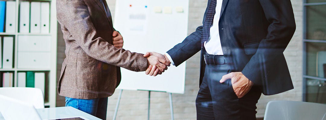 Successful businessmen handshaking after negotiation